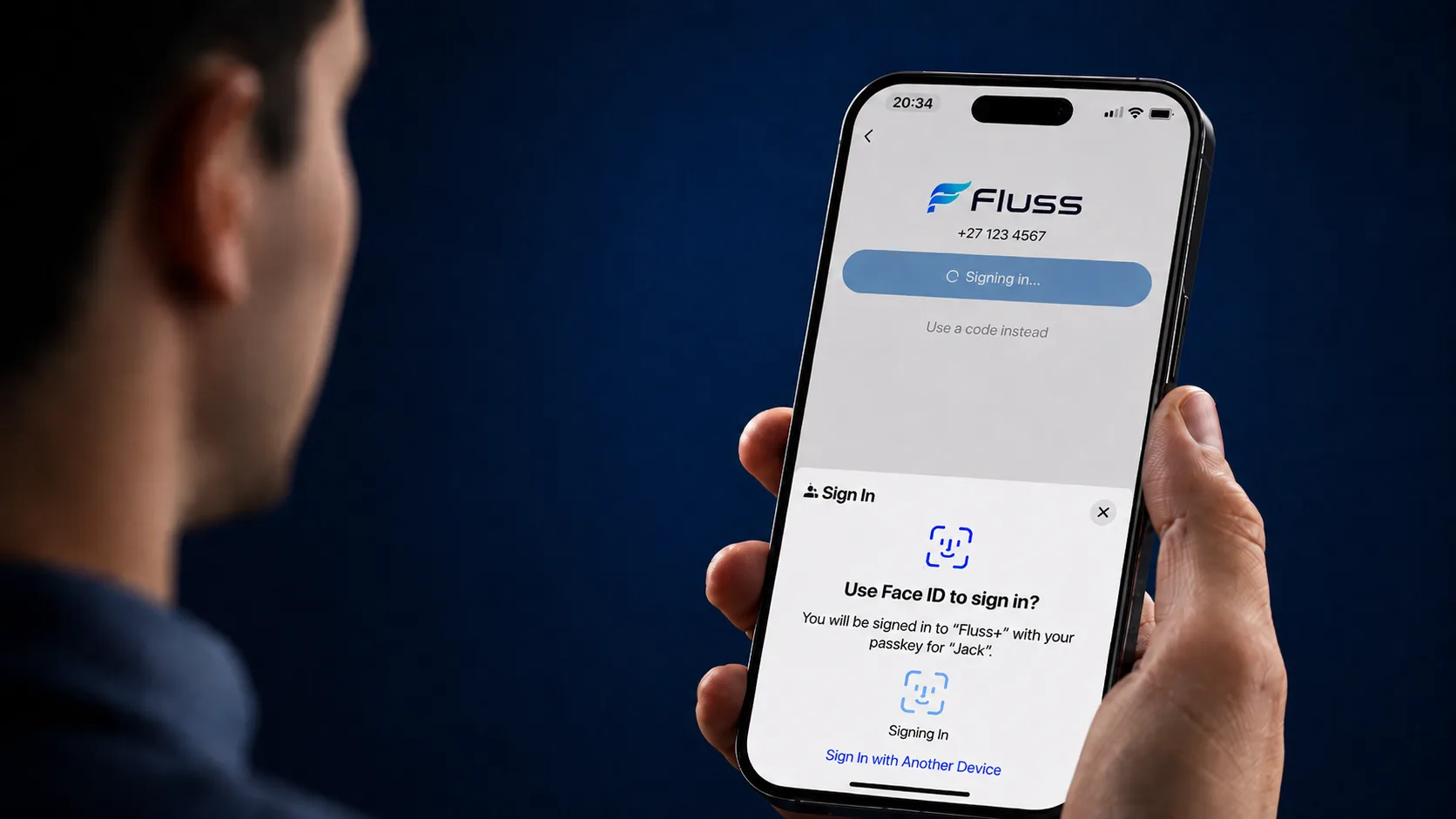 A user signing in to the Fluss+ app with a face scan